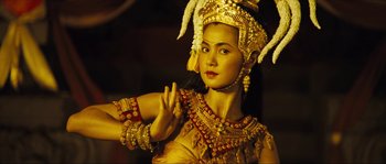 Movie still from “Ong Bak 2” (2008), directed by Tony Jaa – A beautiful woman in a gold dress and headdress; Close Up shot, Low angle