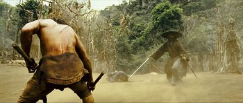 Movie still from “Ong Bak 2” (2008), directed by Tony Jaa – Two men are fighting in the dirt with swords; Wide shot, Low angle