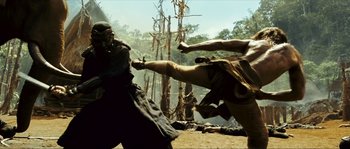 Movie still from “Ong Bak 2” (2008), directed by Tony Jaa – Two men are fighting in the jungle; Wide shot, Low angle