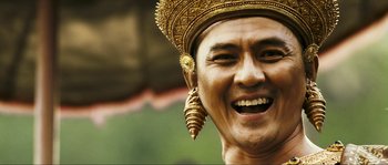 Movie still from “Ong Bak 2” (2008), directed by Tony Jaa – A person wearing a golden headpiece; Close Up shot, Low angle