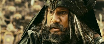 Movie still from “Ong Bak 2” (2008), directed by Tony Jaa – A person with a beard; Close Up shot, Low angle