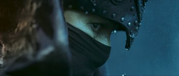 Movie still from “Ong Bak 2” (2008), directed by Tony Jaa – A person wearing a helmet; Extreme Close Up shot, Low angle
