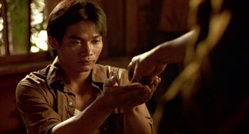 Movie still from “Ong-Bak: The Thai Warrior” (2003), directed by Prachya Pinkaew – A man holding his hand out to another man; Close Up shot, Over the shoulder angle