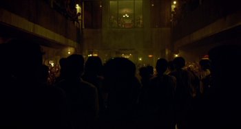 Movie still from “Ong-Bak: The Thai Warrior” (2003), directed by Prachya Pinkaew – A group of people standing in front of a building; Extreme Wide shot, Low angle