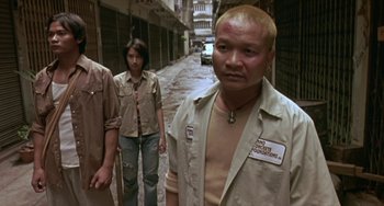 Movie still from “Ong-Bak: The Thai Warrior” (2003), directed by Prachya Pinkaew – A group of people standing on a street; Medium shot, High angle