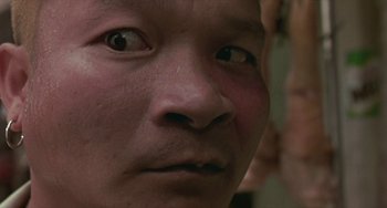 Movie still from “Ong-Bak: The Thai Warrior” (2003), directed by Prachya Pinkaew – A person's eyes and nose; Extreme Close Up shot, Low angle