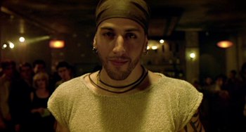 Movie still from “Ong-Bak: The Thai Warrior” (2003), directed by Prachya Pinkaew – A person wearing a hat; Close Up shot, Low angle