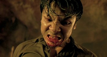 Movie still from “Ong-Bak: The Thai Warrior” (2003), directed by Prachya Pinkaew – A person with blood on his face; Close Up shot, High angle