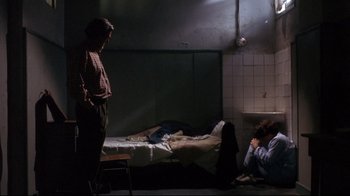 Movie still from “Open Your Eyes” (1997), directed by Alejandro Amenábar – Two people sitting on a bed in a dark room; Wide shot, Over the shoulder angle