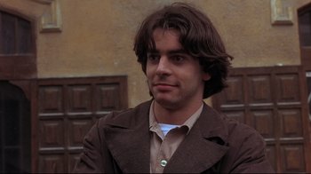 Movie still from “Open Your Eyes” (1997), directed by Alejandro Amenábar – A man with long brown hair wearing a brown jacket; Close Up shot, Low angle