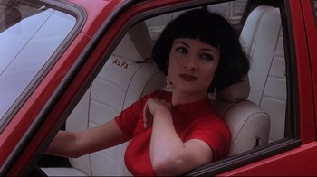 Movie still from “Open Your Eyes” (1997), directed by Alejandro Amenábar – A woman sitting in the driver's seat of a car; Close Up shot, Low angle