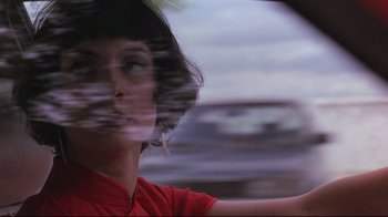 Movie still from “Open Your Eyes” (1997), directed by Alejandro Amenábar – A woman in a red shirt is driving a car; Close Up shot, Over the shoulder angle