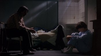 Movie still from “Open Your Eyes” (1997), directed by Alejandro Amenábar – Two people sitting on the ground in a room; Wide shot, Over the shoulder angle