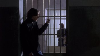 Movie still from “Open Your Eyes” (1997), directed by Alejandro Amenábar – A man standing in front of a jail cell; Medium shot, Low angle