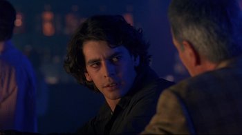 Movie still from “Open Your Eyes” (1997), directed by Alejandro Amenábar – A young man with long hair is looking at the camera while another man looks at him; Close Up shot, Over the shoulder angle