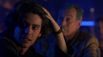 Movie still from “Open Your Eyes” (1997), directed by Alejandro Amenábar – A young man with his hand on his head and another man with his hand on his head; Close Up shot, Over the shoulder angle