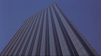 Movie still from “Open Your Eyes” (1997), directed by Alejandro Amenábar – Looking up at a very tall skyscraper building; Extreme Wide shot, Low angle