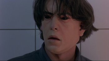 Movie still from “Open Your Eyes” (1997), directed by Alejandro Amenábar – A person's face in a bathroom; Close Up shot, High angle