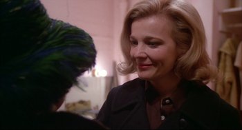 Movie still from “Opening Night” (1977), directed by John Cassavetes – A woman in a black jacket is talking to another woman; Close Up shot, Over the shoulder angle