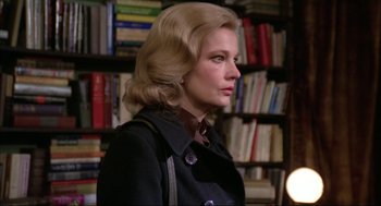 Movie still from “Opening Night” (1977), directed by John Cassavetes – A woman with blonde hair wearing a black coat; Close Up shot, Over the shoulder angle