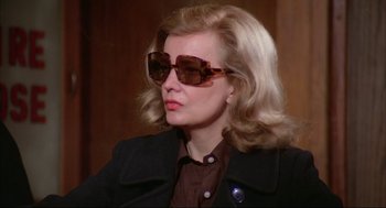 Movie still from “Opening Night” (1977), directed by John Cassavetes – A woman with blonde hair wearing sunglasses and a jacket; Close Up shot, Over the shoulder angle