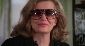 Movie still from “Opening Night” (1977), directed by John Cassavetes – A person wearing sunglasses; Close Up shot, Low angle