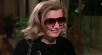 Movie still from “Opening Night” (1977), directed by John Cassavetes – A person wearing sunglasses; Close Up shot, High angle