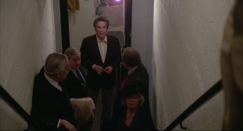 Movie still from “Opening Night” (1977), directed by John Cassavetes – A group of people standing in a hallway; Wide shot, High angle