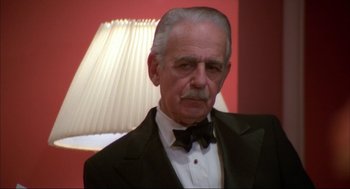 Movie still from “Opening Night” (1977), directed by John Cassavetes – An older man wearing a tuxedo in front of a lamp; Close Up shot, Low angle