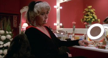 Movie still from “Opening Night” (1977), directed by John Cassavetes – An older woman sitting in front of a mirror in a dressing room; Medium shot, Over the shoulder angle