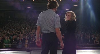 Movie still from “Opening Night” (1977), directed by John Cassavetes – A man and a woman standing in front of an audience; Medium shot, Over the shoulder angle