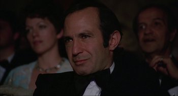 Movie still from “Opening Night” (1977), directed by John Cassavetes – A person wearing a tuxedo; Close Up shot, High angle