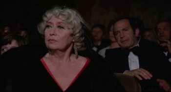Movie still from “Opening Night” (1977), directed by John Cassavetes – An older woman in a black and red dress; Close Up shot, Over the shoulder angle