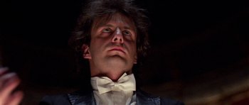 Movie still from “Opera” (1987), directed by Dario Argento – A person wearing a bow tie; Close Up shot, Low angle