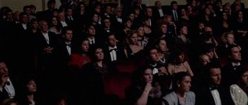 Movie still from “Opera” (1987), directed by Dario Argento – A group of people sitting in a theater; Wide shot, High angle
