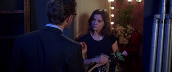 Movie still from “Opera” (1987), directed by Dario Argento – A man and a woman talking in front of a mirror; Medium shot, Over the shoulder angle