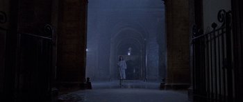 Movie still from “Opera” (1987), directed by Dario Argento – A woman walking in the dark in a building; Extreme Wide shot, High angle
