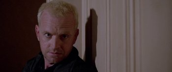 Movie still from “Opera” (1987), directed by Dario Argento – A person wearing a black shirt; Close Up shot, Low angle