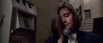 Movie still from “Opera” (1987), directed by Dario Argento – A woman is holding a phone up to her ear; Close Up shot, High angle