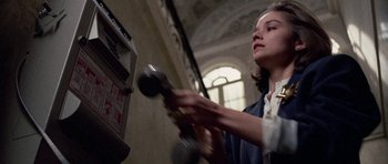 Movie still from “Opera” (1987), directed by Dario Argento – A young girl is playing a video game; Medium shot, Low angle