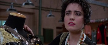 Movie still from “Opera” (1987), directed by Dario Argento – A person holding a bag; Close Up shot, Over the shoulder angle