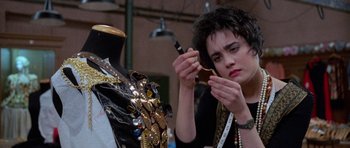 Movie still from “Opera” (1987), directed by Dario Argento – A woman is working on a mannequin in a dressmaker's shop; Close Up shot, Over the shoulder angle