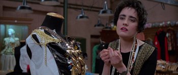 Movie still from “Opera” (1987), directed by Dario Argento – A woman holding a bird in front of a mannequin; Close Up shot, Over the shoulder angle