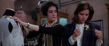 Movie still from “Opera” (1987), directed by Dario Argento – A woman in a black jacket and a man in a black jacket; Medium shot, Over the shoulder angle