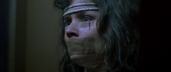 Movie still from “Opera” (1987), directed by Dario Argento – A woman with taped mouth and taped eyes; Close Up shot, Low angle