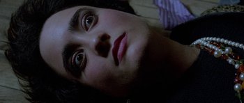 Movie still from “Opera” (1987), directed by Dario Argento – A person's face as they lay on a bed; Close Up shot, Overhead angle