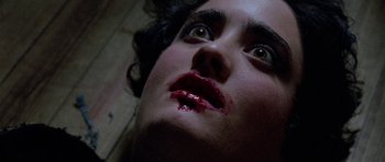 Movie still from “Opera” (1987), directed by Dario Argento – A person's face covered in blood; Close Up shot, Overhead angle