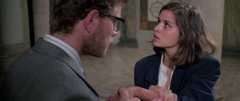 Movie still from “Opera” (1987), directed by Dario Argento – A man and a woman are holding hands; Close Up shot, Over the shoulder angle