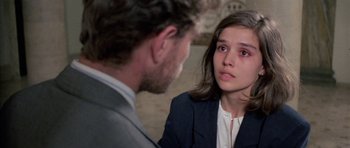 Movie still from “Opera” (1987), directed by Dario Argento – A man and a woman are talking to each other; Close Up shot, Over the shoulder angle