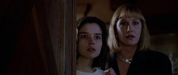 Movie still from “Opera” (1987), directed by Dario Argento – A woman and a girl standing next to each other in a room; Close Up shot, Low angle